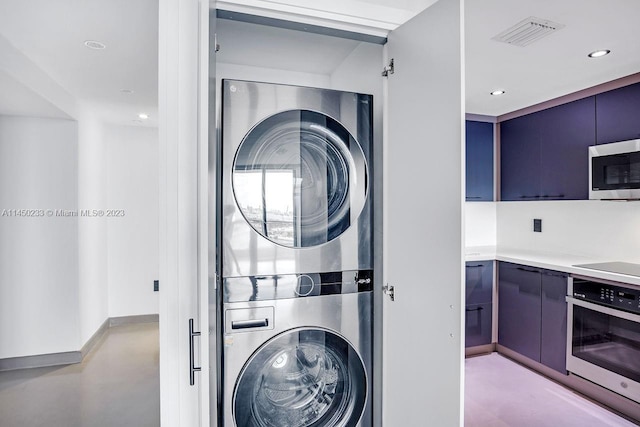 laundry area with stacked washer and clothes dryer