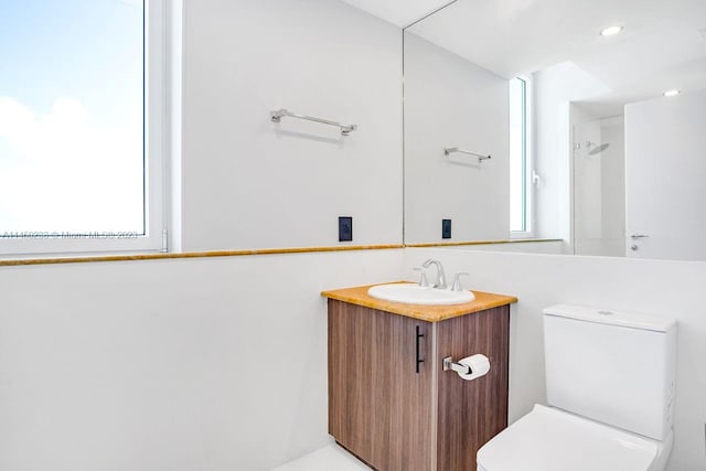 bathroom featuring toilet and large vanity