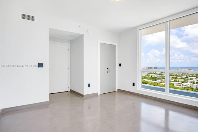 unfurnished room featuring concrete floors