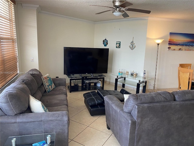 living room with light tile floors, ornamental molding, ceiling fan, and a textured ceiling