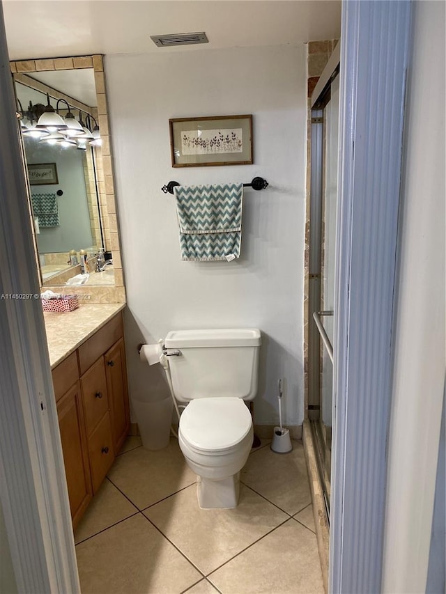 bathroom featuring tile floors, oversized vanity, and toilet