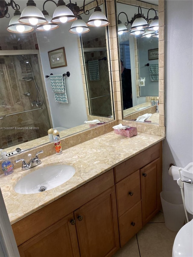 bathroom featuring toilet, tile floors, and oversized vanity