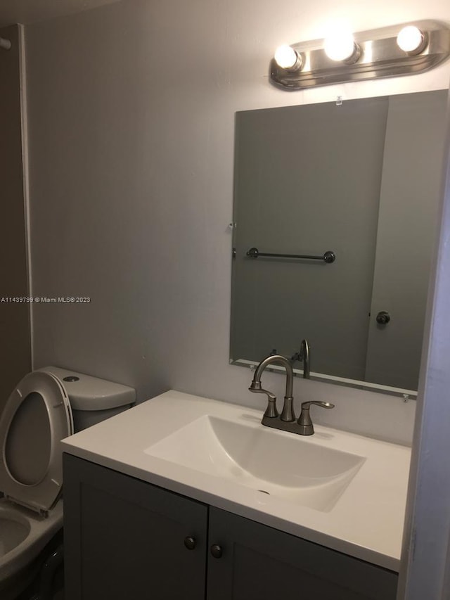 bathroom featuring oversized vanity and toilet