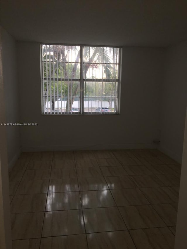 tiled empty room with plenty of natural light