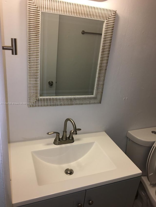 bathroom featuring vanity and toilet