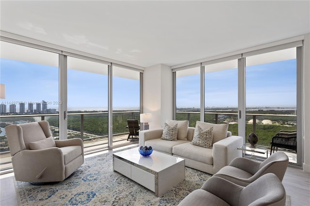 living room with light hardwood / wood-style floors and expansive windows