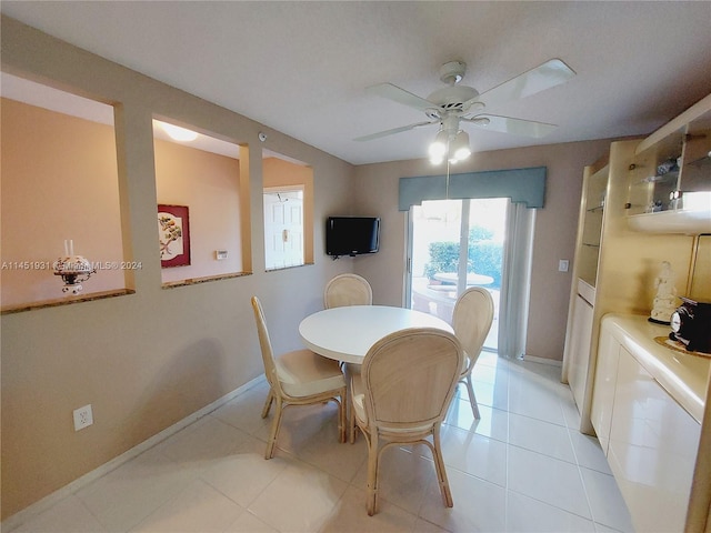 tiled dining space with ceiling fan