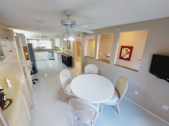 dining space with ceiling fan and light tile flooring