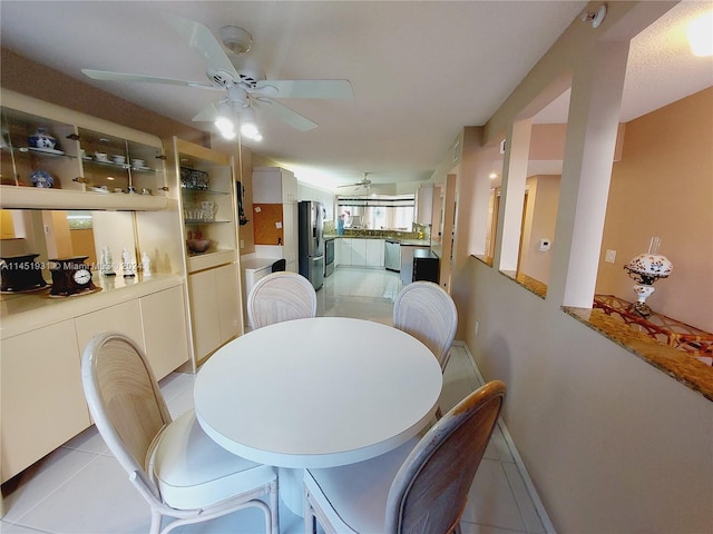 dining room featuring ceiling fan and light tile floors