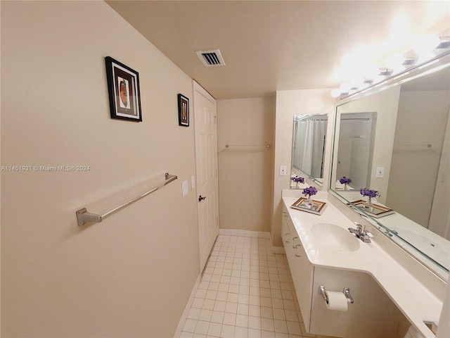 bathroom with tile flooring and vanity