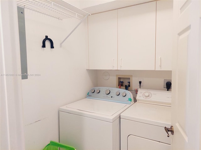 laundry area featuring hookup for a washing machine, separate washer and dryer, electric dryer hookup, and cabinets