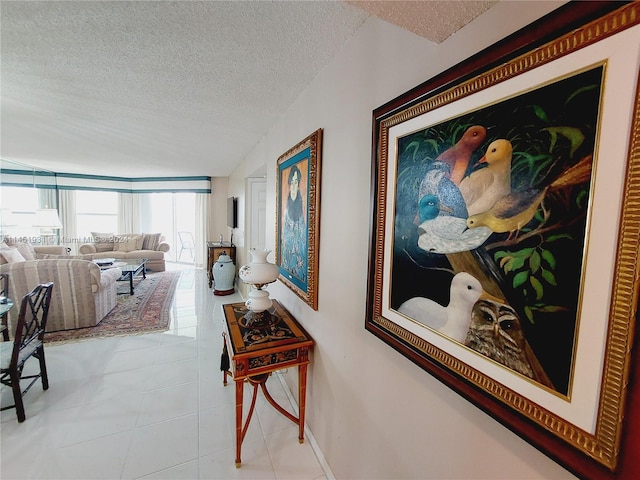 hall featuring tile flooring and a textured ceiling