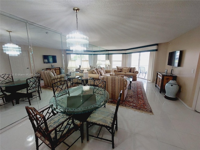 dining space featuring an inviting chandelier, a textured ceiling, and light tile floors