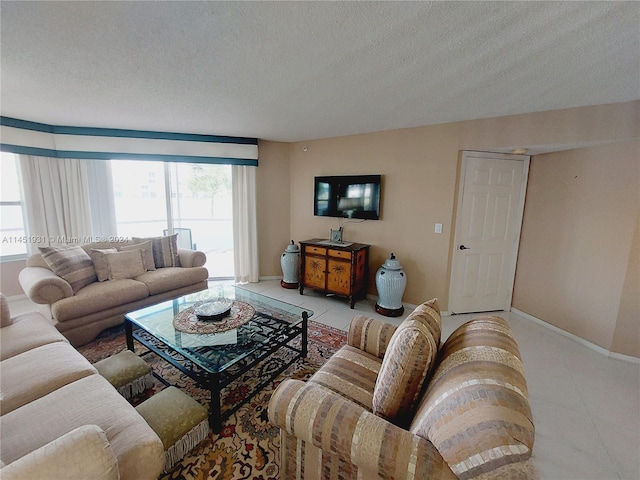 living room with a textured ceiling and light tile floors