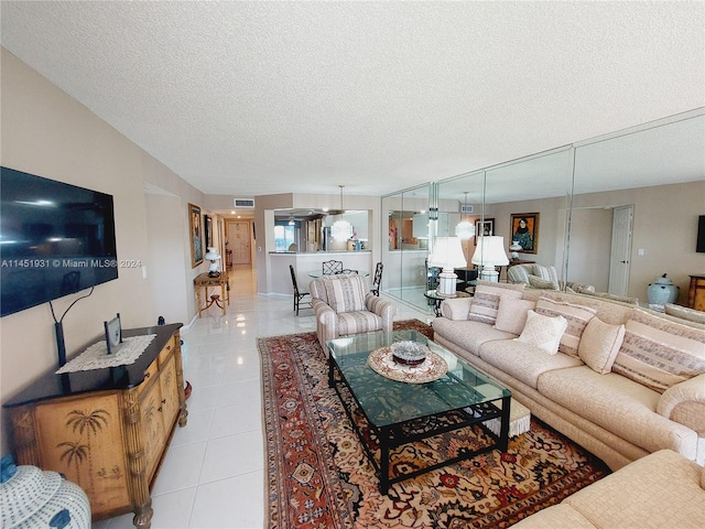 tiled living room featuring a textured ceiling