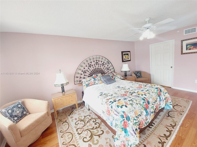 bedroom with ceiling fan and hardwood / wood-style floors