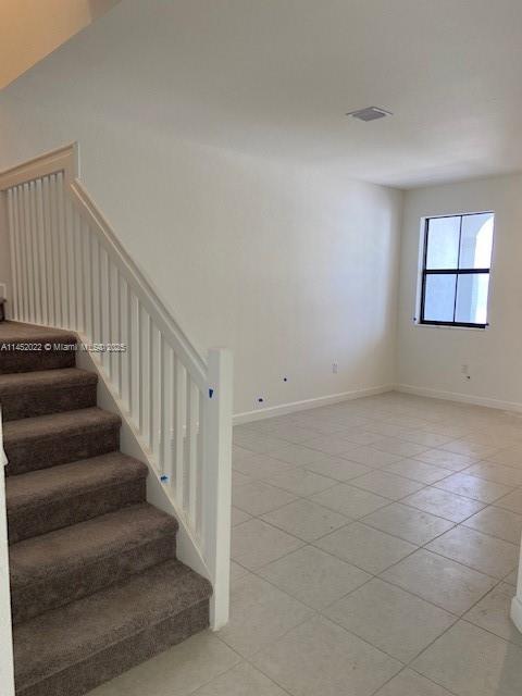 staircase with tile patterned flooring