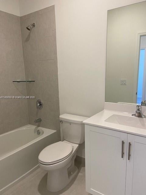 full bathroom featuring toilet, vanity, and tiled shower / bath