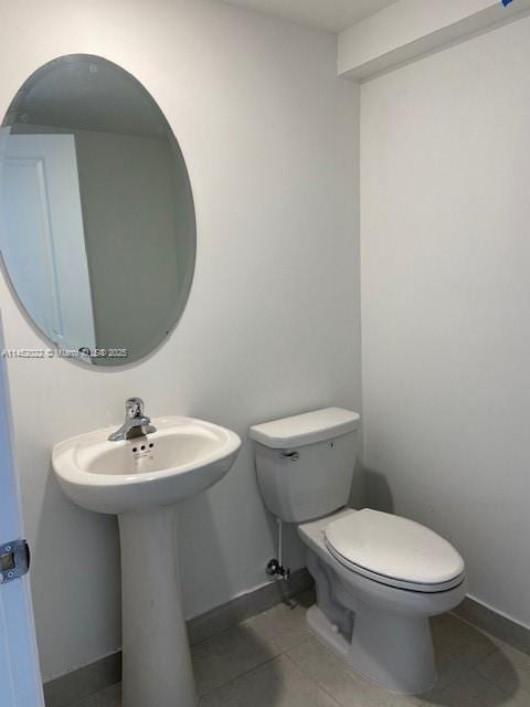 bathroom with tile patterned floors and toilet