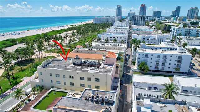 aerial view with a water view and a view of the beach