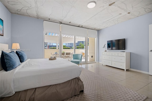 bedroom featuring light tile patterned flooring and access to exterior