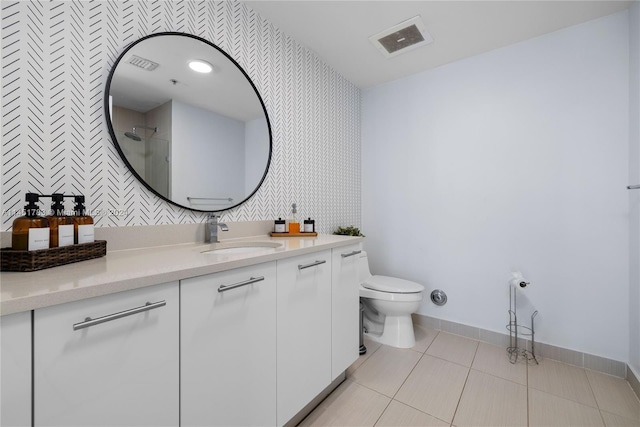 bathroom featuring toilet, tile patterned floors, and vanity