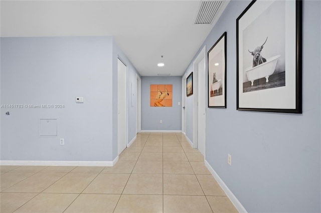 corridor with light tile patterned flooring