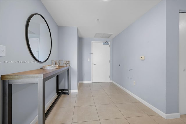 hall featuring light tile patterned flooring