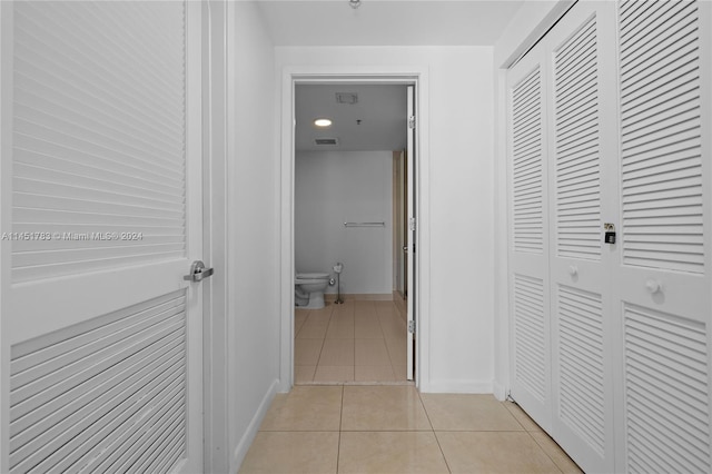 corridor featuring light tile patterned floors