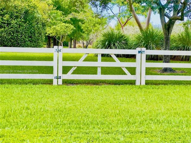 view of gate featuring a lawn