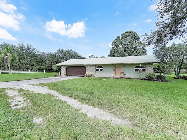 ranch-style home with a front yard and a garage