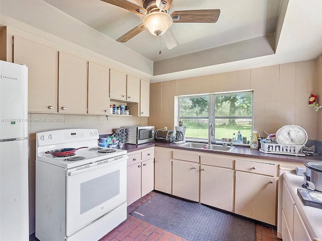 kitchen featuring white appliances, ceiling fan, and sink