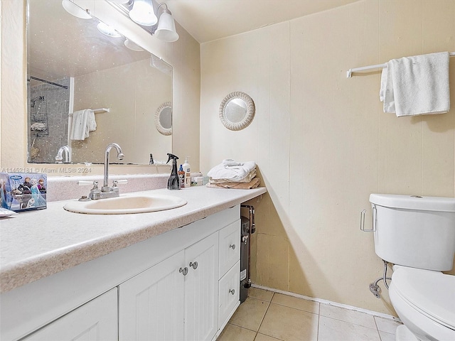 bathroom featuring toilet, tile floors, and vanity