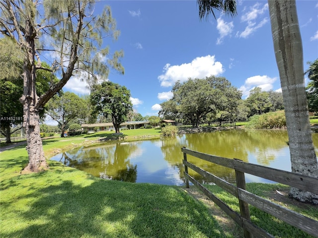 view of dock featuring a yard and a water view