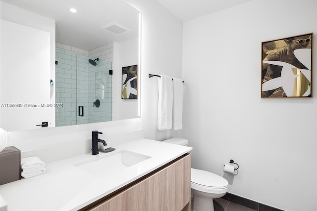 bathroom featuring vanity, tile flooring, and toilet