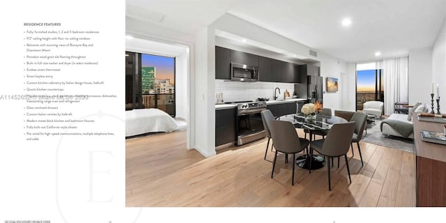 dining space featuring sink and light hardwood / wood-style flooring