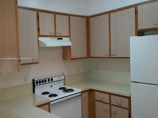 kitchen featuring white appliances and light brown cabinetry