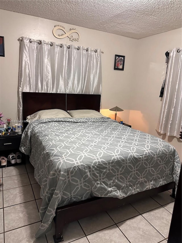 tiled bedroom with a textured ceiling