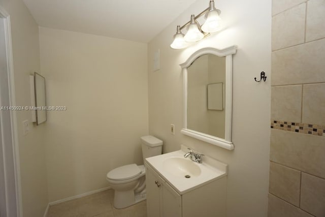 bathroom featuring toilet, tile floors, and vanity