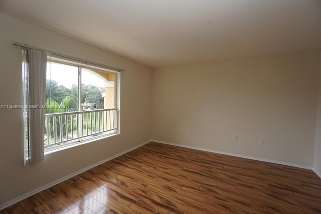 spare room with dark wood-type flooring