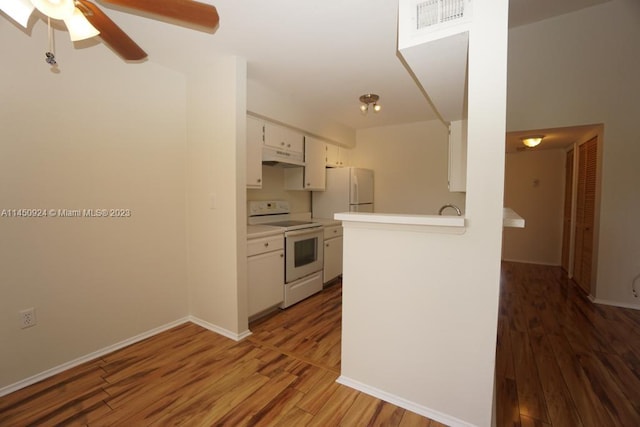 kitchen featuring white appliances, white cabinets, dark hardwood / wood-style floors, and ceiling fan