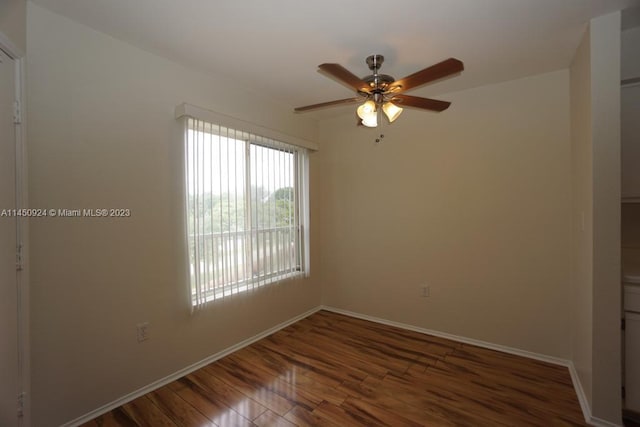 unfurnished room with ceiling fan and dark wood-type flooring