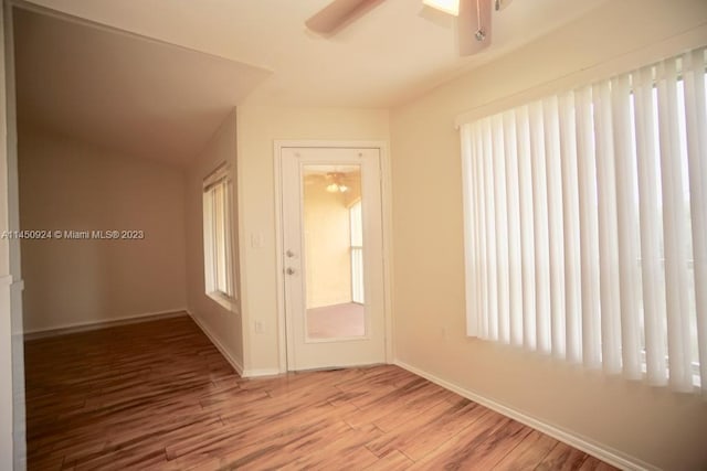 spare room with ceiling fan and light wood-type flooring