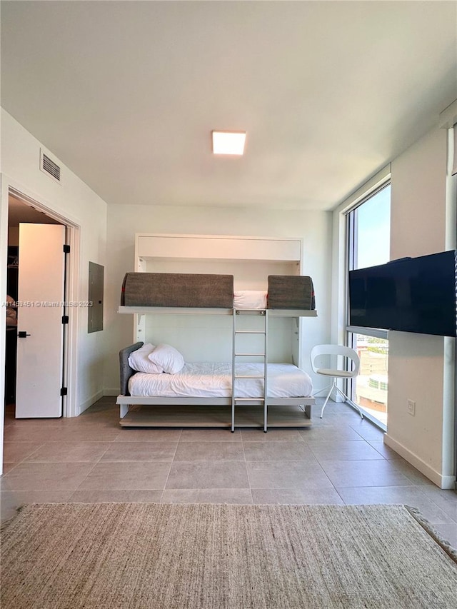 unfurnished bedroom with light tile floors