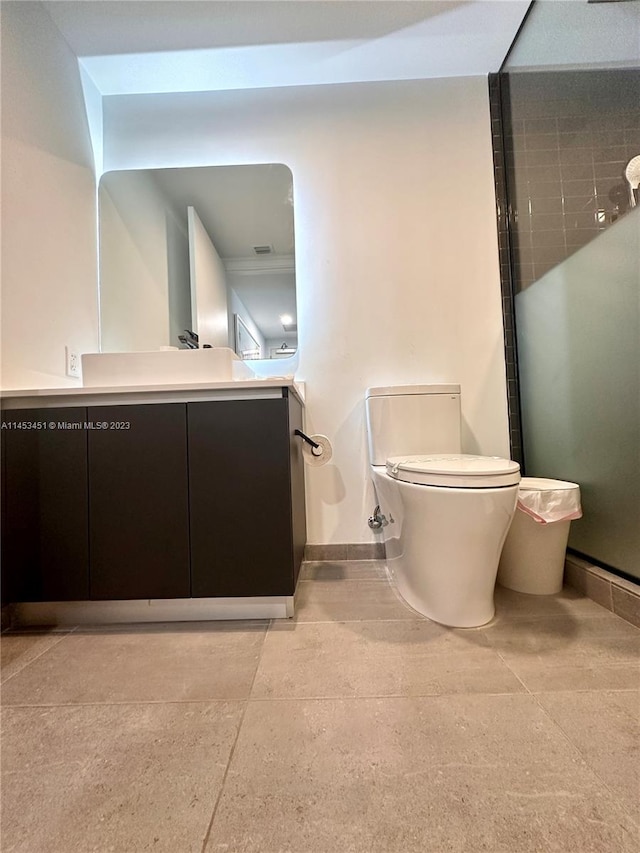 bathroom with tile floors, toilet, and vanity