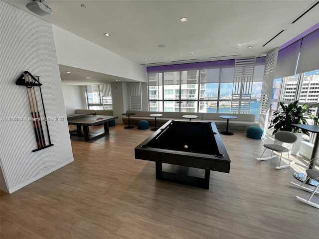 game room featuring billiards, a healthy amount of sunlight, and hardwood / wood-style floors