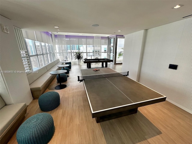 game room featuring expansive windows, pool table, and light hardwood / wood-style floors