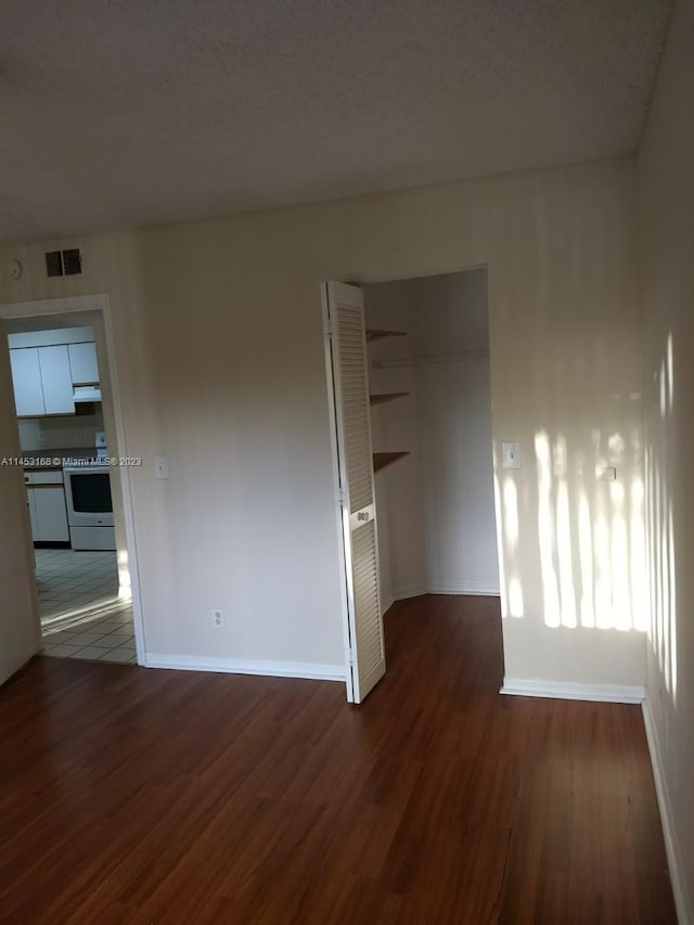 spare room featuring dark hardwood / wood-style flooring