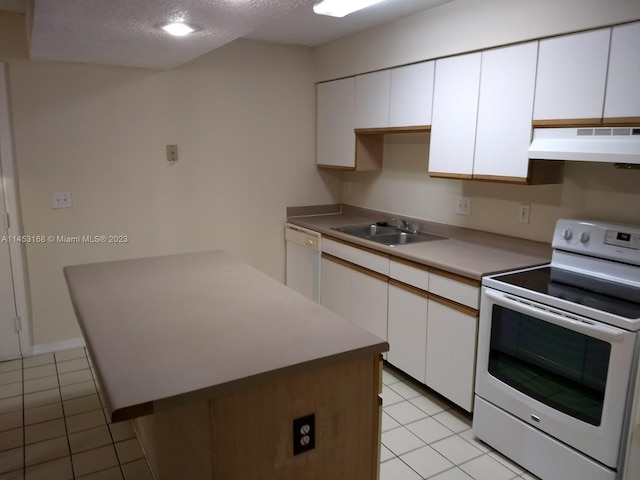 kitchen featuring white cabinets, light tile flooring, white appliances, and custom exhaust hood