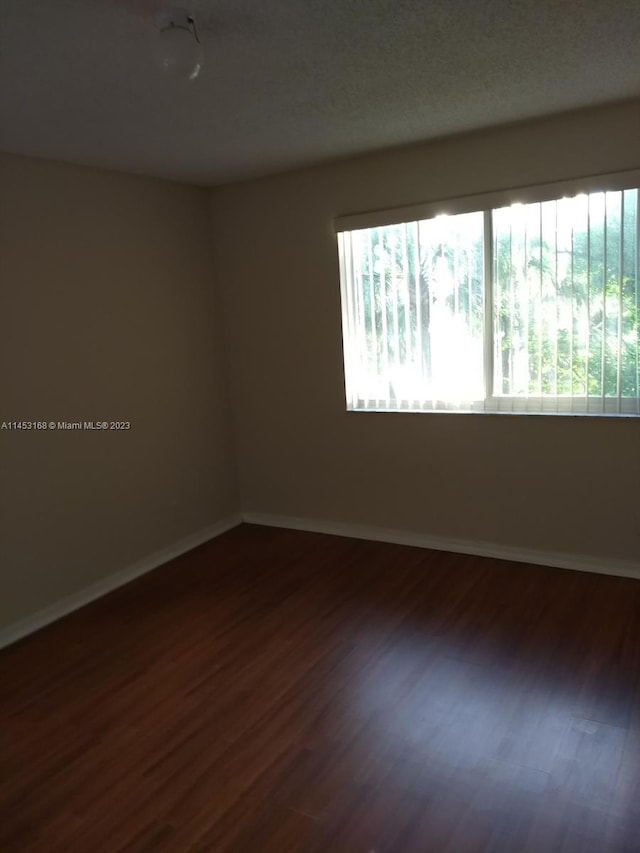 spare room with hardwood / wood-style floors